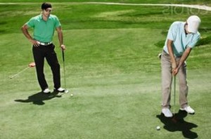 Two men playing golf