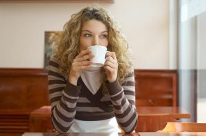 woman holding tea cup sipping coffee and thinking about something-perhaps what she had learned in 2019.